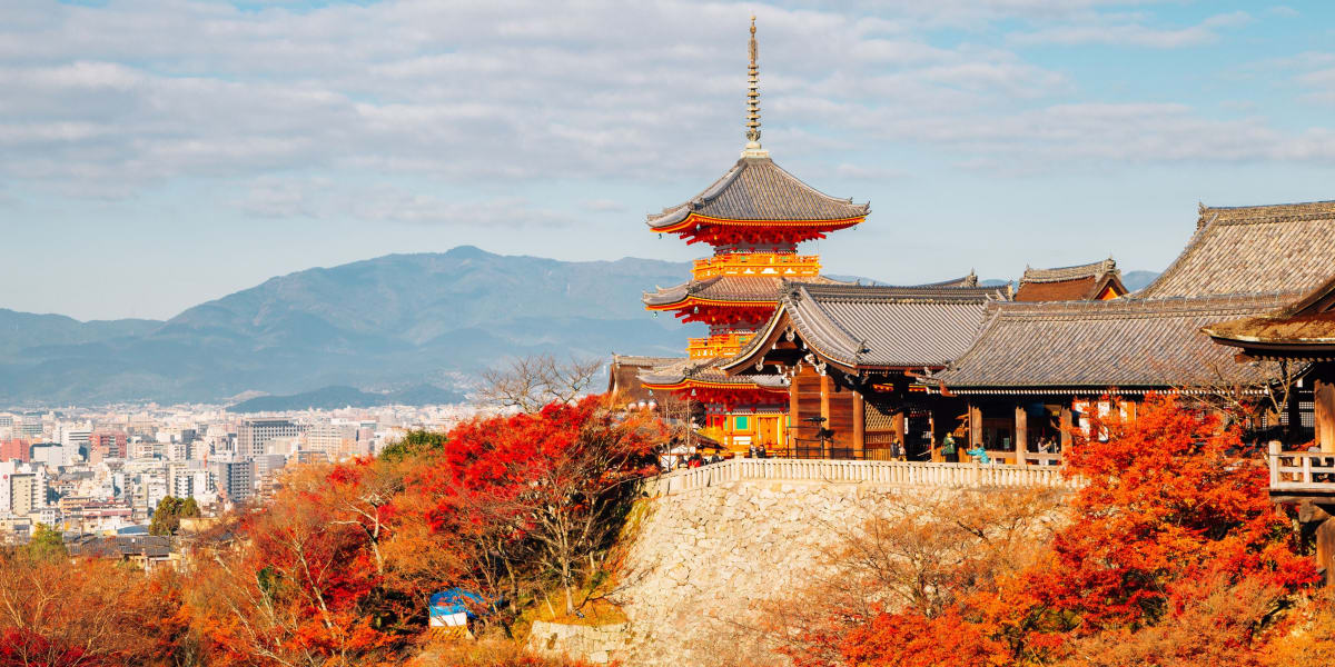 Kiyomizudera Temple pagoda above Kyoto cityscape in autumn foliage